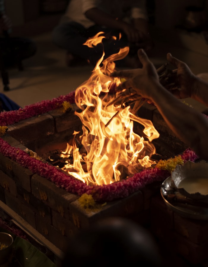 A havan fire burning in a brick kund during a ritual